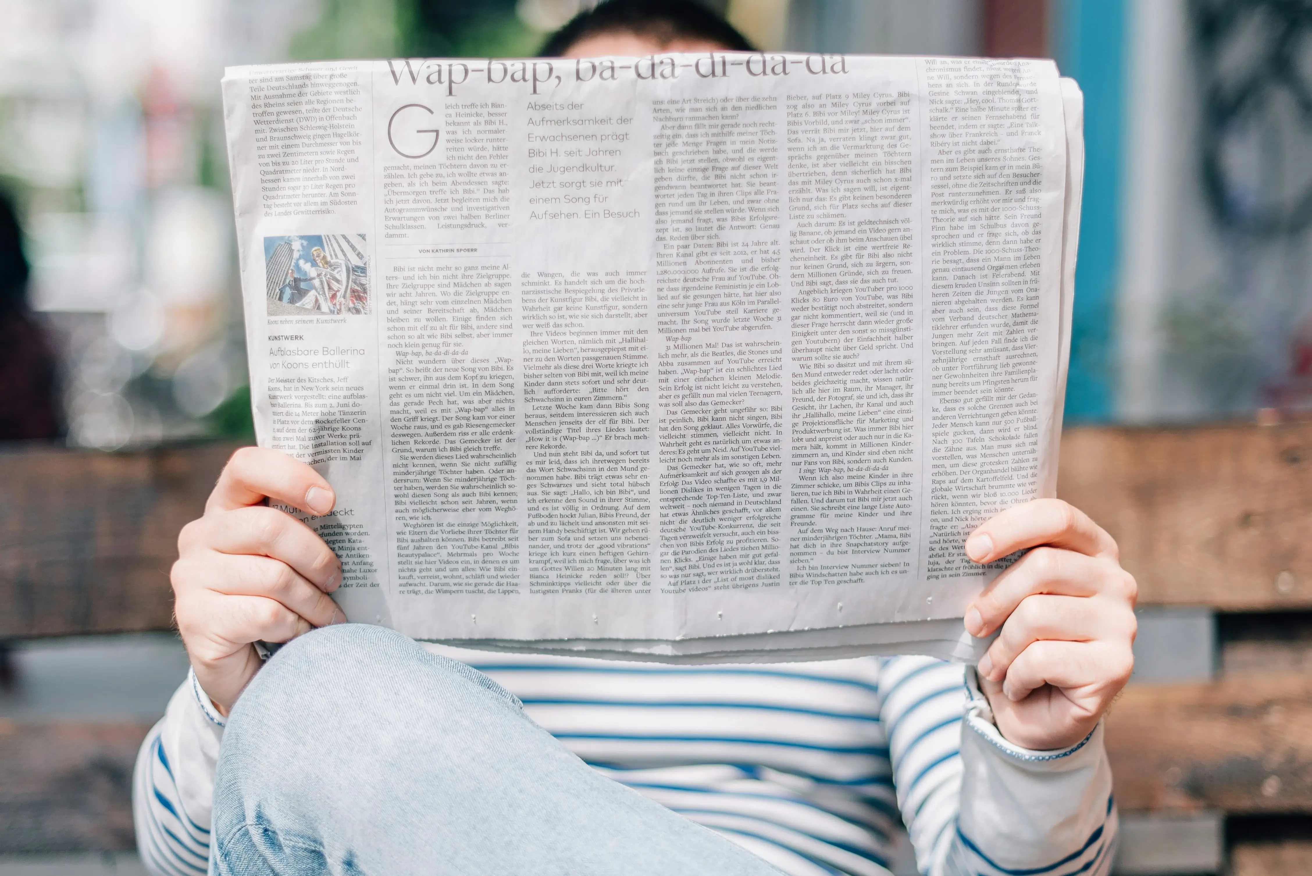 Lady Reading Expanded Newspaper